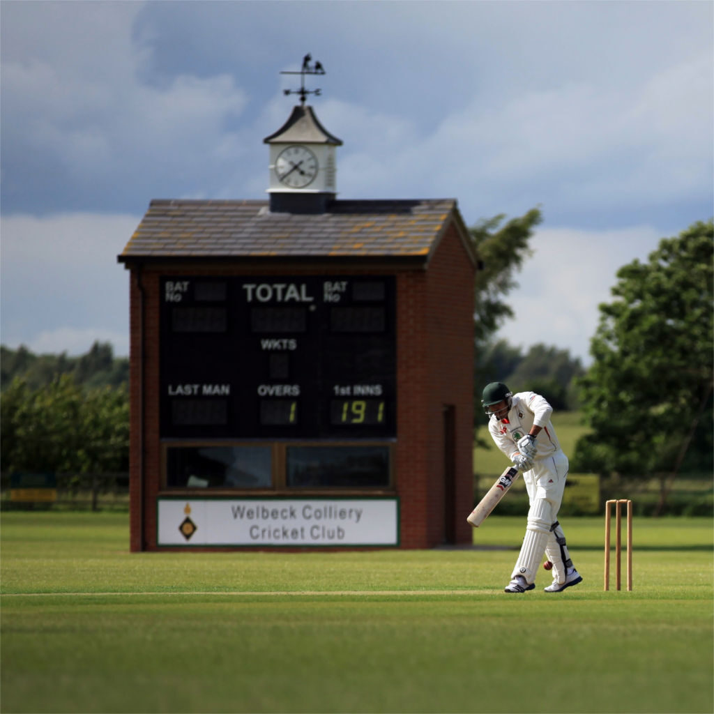 Scorebox with batter representing cricket life at a club